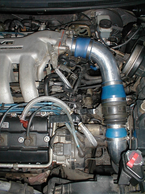 A couple of weeks ago, while the engine was torn apart, I noticed lots of gunk, carbon, oil, you know... gunk in the intake manifold. This modification adds a small catch tank to the PCV line to seperate oil vapors from the air passing through. By the way, I made the mounting bracket out of a bracket that is used to mount a light fixture in its electrical box. I flattened it, bent the 90 degree side and then wrapped it in electrical tape.